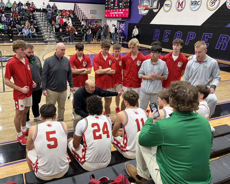 La Salle-Peru head coach John Senica (at center) instructs his Cavaliers during a timeout in their 70-36 win over Bremen on Friday, Dec. 26, 2025, at the Plano Christmas Classic.