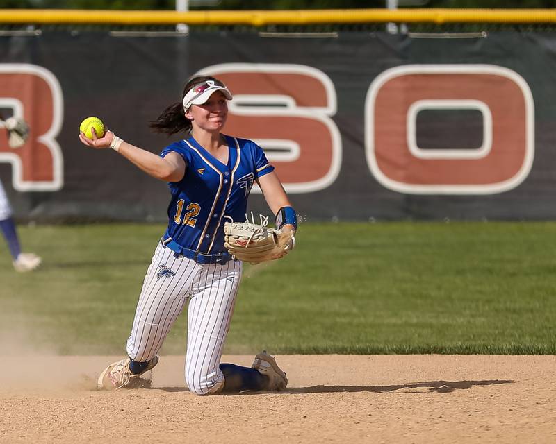 Wheaton North's Macy Pomatto (12) makes a throw to first after making a sliding stop at second during Class 4A Plainfield North Sectional final softball game between Wheaton North at Oswego. May 31th, 2024.