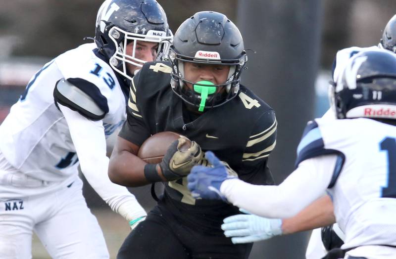 Sycamore's Tyler Curtis looks to get by Nazareth's James Penley Saturday, Nov. 18, 2022, during the state semifinal game at Sycamore High School.