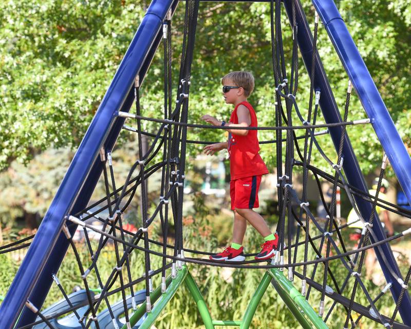 Harvey Powell, 8, of Elburn enjoys using the new playground on Saturday Aug. 16, 2025, during the dedication ceremony held at Prairie Park in Elburn.