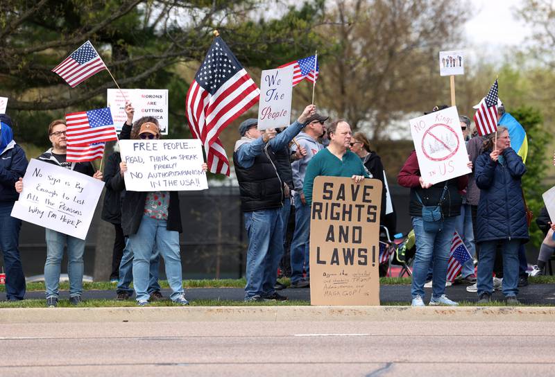 Protesters line Sycamore Road Saturday, May 3, 2025, at Hopkins Park in DeKalb during a May Day Rally for Democracy to protest against Trump administration policies.