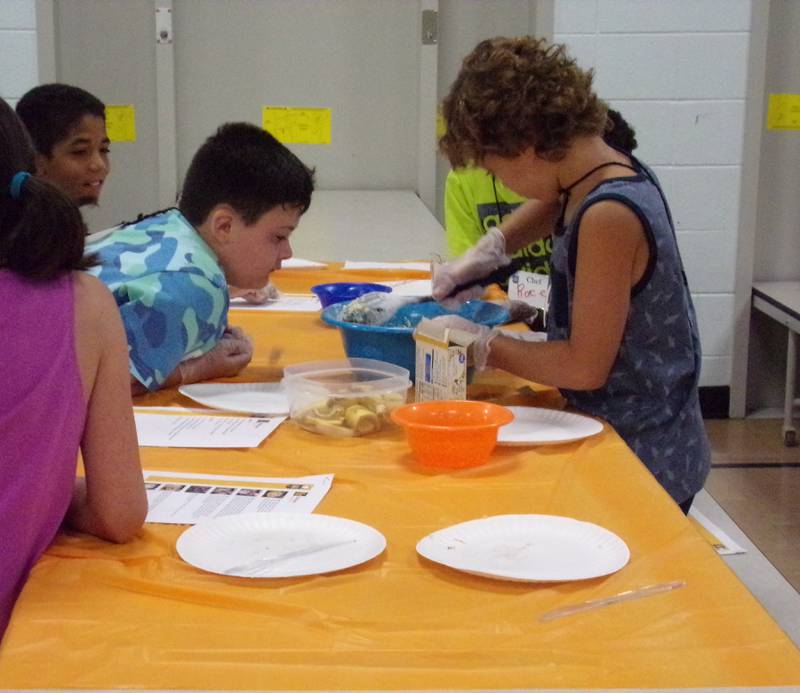 Young chefs stir together ingredients Wednesday, June 22, 2022, at Northlawn School in Streator during the Illinois Young Chefs program led by the University of Illinois Extension.