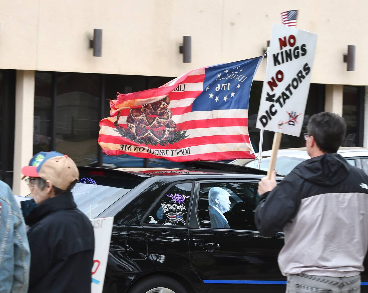 A motorist in support of President Donald Trump drove their vehicle around the Ogle County courthouse square numerous times during the May Day rally on a Friday, May 1, 2026 in Oregon, Illinois. Approximately 100 people turned out to display signs critical of Trump and his administration during the two-hour event.