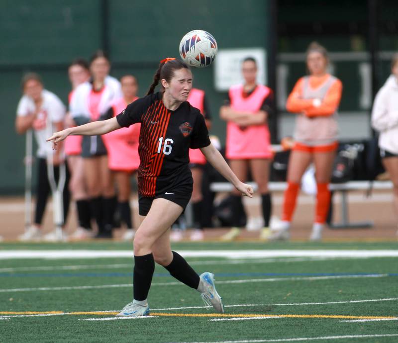 St. Charles East's Averie Foulkes heads the ball during a Class 3A Glenbard West Sectional semifinal game against St. Charles North on Tuesday, May 27, 2025 in Glen Ellyn.