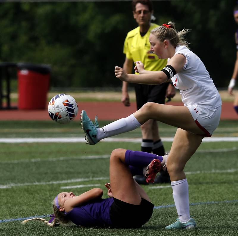 Timothy Christian's Samantha Drye kicks the ball away from a fallen Williamsville's Calynn Frye in the IHSA Class 1A State Girls Soccer third-place match on Friday, June 6, 2025, at North Central College in Naperville.