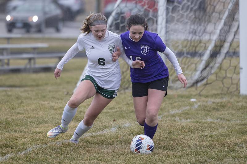 Dixon’s Emily Smith and Alleman’s Mackenzie Burkett fight for the ball Thursday, March 16, 2023.
