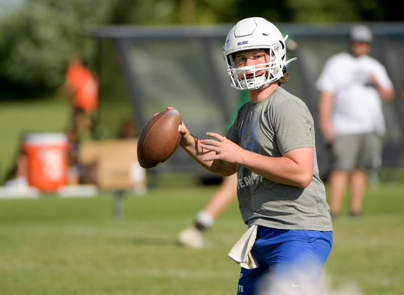 Burlington Central’s quarterback looks for a receiver during a 7 on 7 football against Oswego in Maple Park on Tuesday, July 12, 2022.