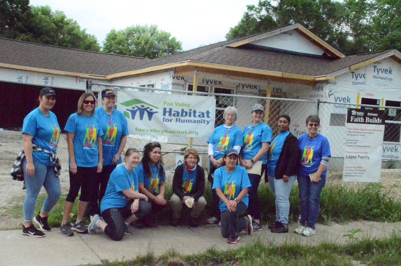 Women pose for a photo Saturday, June 4, before performing light construction tasks at 656 Spruce St. in Aurora. Ten volunteers from surrounding towns including Yorkville, Aurora, North Aurora, Batavia, Joliet and Winfield participated in the fifth annual Women Build by Fox Valley Habitat for Humanity.