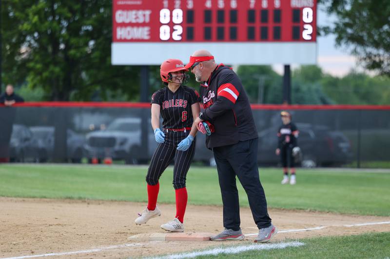Bradley-Bourbonnais’ Avery Moutrey celebrates a two-RBI single with assistant coach Mark Kohl during the Boilermakers' 8-0 victory over Normal Community in the IHSA Class 4A Bradley-Bourbonnais Regional semifinal on Tuesday, May, 27, 2025.