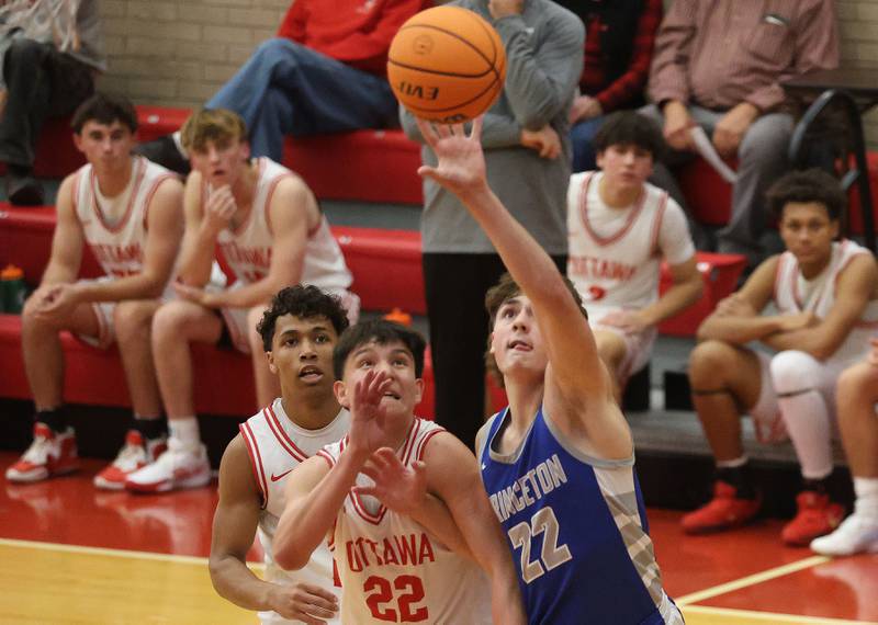 Princeton's Deacon Gutshall knocks the ball away from Ottawa defenders Dom Parks and Hezekiah Joachim during the Dean Riley Shootin' The Rock Thanksgiving Tournament on Monday Nov. 24, 2025 in Kingman Gymnasium at Ottawa High School.