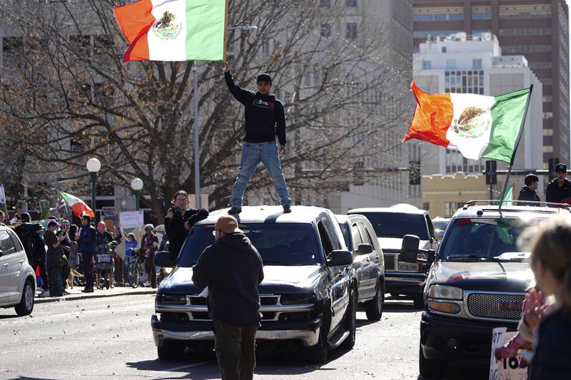 Participants block Lincoln Street during a political protest outside the State Capitol Wednesday, Feb. 5, 2025, in Denver. (AP Photo/David Zalubowski)