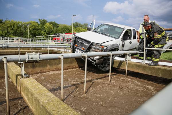 Pickup truck pushed to the edge of wastewater treatment tank following crash Monday in Woodstock