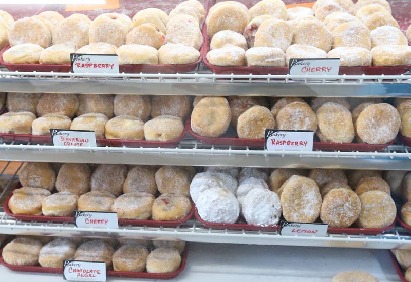 Hundreds of Paczki's are in a display case at the Spring Valley Bakery on Tuesday, Feb. 13, 2024 downtown Spring Valley. A Paczki is a popular Polish-American tradition where bakeries make doughnuts filled with jelly and coated in sugar. The tradition is popular in the Illinois Valley for a Fat Tuesday feast.
