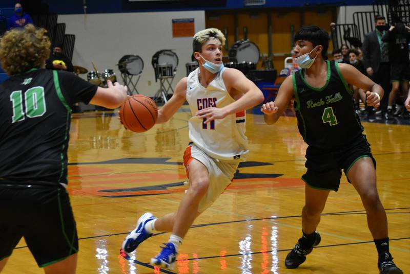 Jake Oates drives to the basket for Genoa-Kingston in the Cogs' 67-56 win over Rock Falls on Thursday, January 6, 2022.