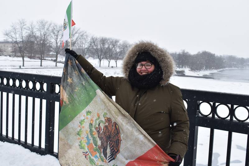 Nora Serrano, a registered nurse at CGH Medical Center in Sterling, shows off her multi-generational family flag with pride Saturday, Feb. 15, 2025, on the First Avenue bridge between Sterling and Rock Falls.