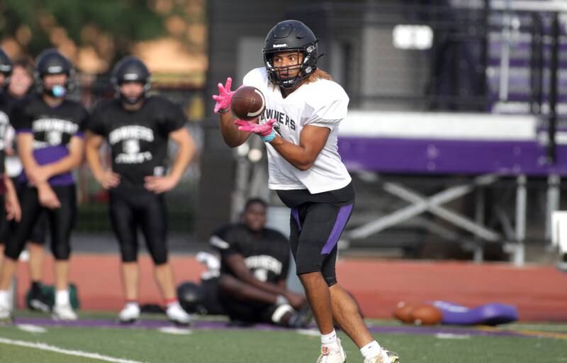 Downers Grove North’s Noah Battle makes a catch during a practice at the school on Tuesday, Aug. 15, 2023.