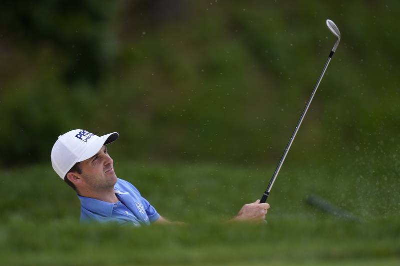 Denny McCarthy hits out of a bunker next to the ninth green during the second round of the John Deere Classic on Friday at TPC Deere Run in Silvis. McCarthy is in second place at 11-under par, four shots behind leader J.T. Poston.