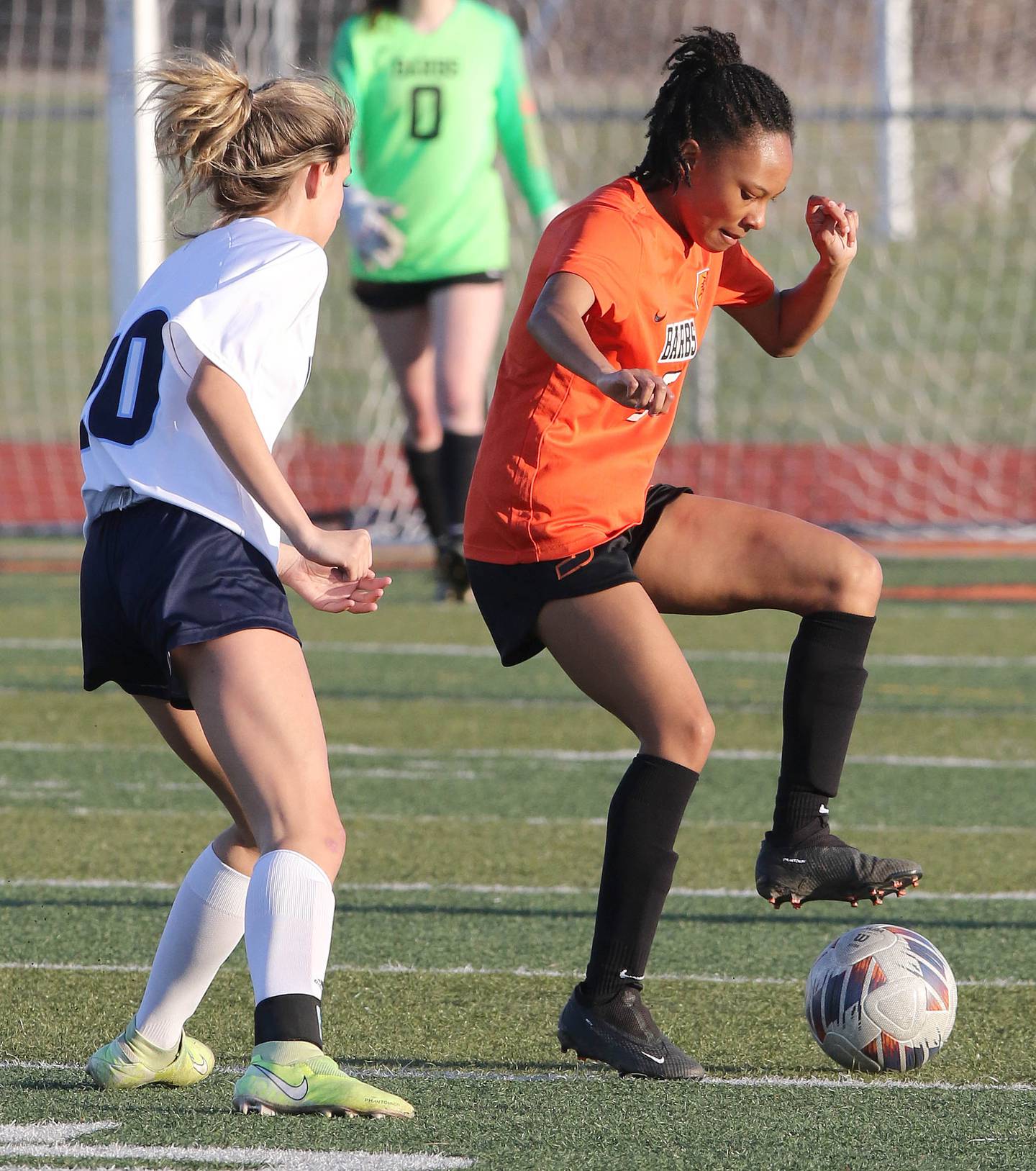 DeKalb's Madison McNeil keeps the ball away from Guilford's Abigail Carlson during their game Monday, April 10, 2023, at DeKalb High School.