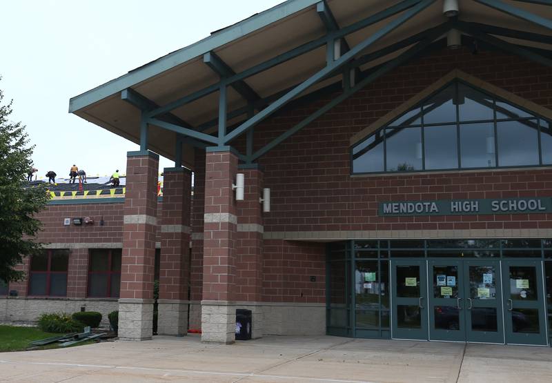 Workers with Sterling Commerical Roofing, place shingles on top of the roof of Mendota High School on Monday July 12, 2021. The school is getting some improvements throughout the summer.