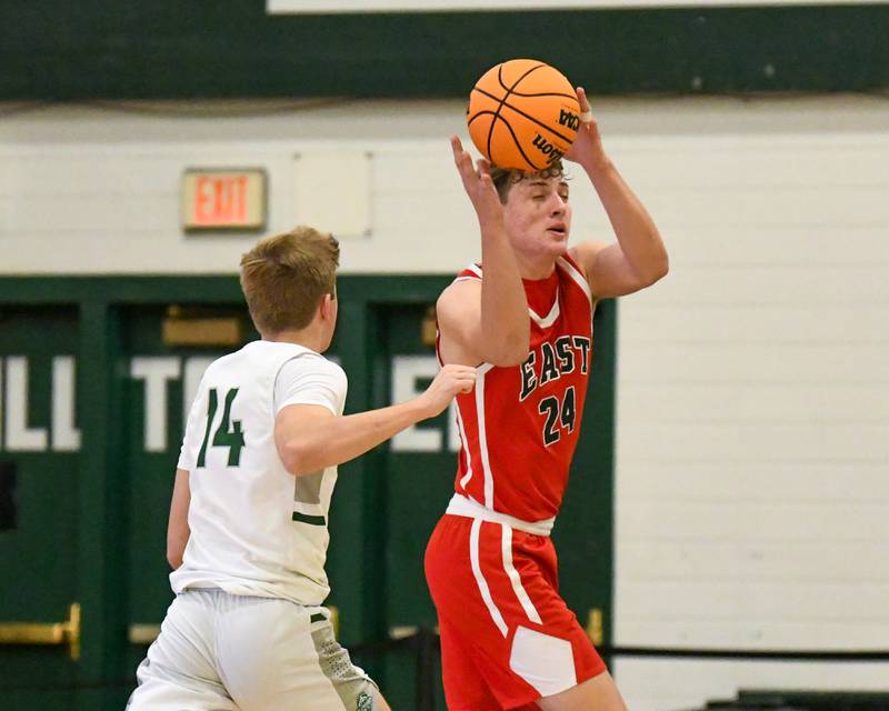 Glenbard East's Sam Walton (24) gets a breakaway pass and makes a basket while being defended by Glenbard West's Finn Sheeley (14) on Wednesday Nov. 26, 2025, during the District 87 Thanksgiving Invitational held at Glenbard West High School.