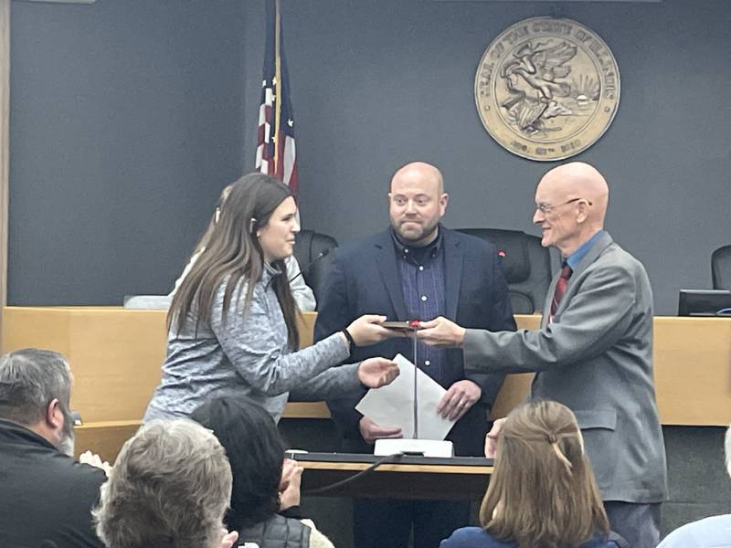 Hanna Waszkowiak (left), an honors student at Trinity Catholic Academy in La Salle, accepts a Student Excellence award from La Salle County Board Chairman Don Jensen (right) while Regional Superintendent of Schools Chris Dvorak (center) looks on Thursday, Feb. 8, 2024, at the county board meeting in Ottawa. Waszkowiak, daughter of Paul and Jynny Waszkowiak of Peru, is an accomplished student-athlete and winner of a statewide handwriting competition. She is one of two winners of the county's Student Excellence Award for February.