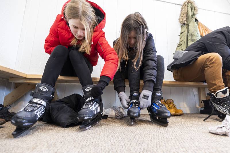 Sofia Dula (left), 13, and Layla Ballotti, 13, lace up the skates for a trip around Dixon Park District’s ice rink Saturday, Jan. 20, 2024. Open hours are dependent on weather. Check the DPD website for updates.