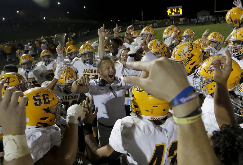 Jacobs Head Coach Brian Zimmerman celebrates with his team after they defeated defeated Prairie Ridge during a Fox Valley Conference football game between Friday, Sept. 16, 2022, at Jacobs High School in Algonquin.