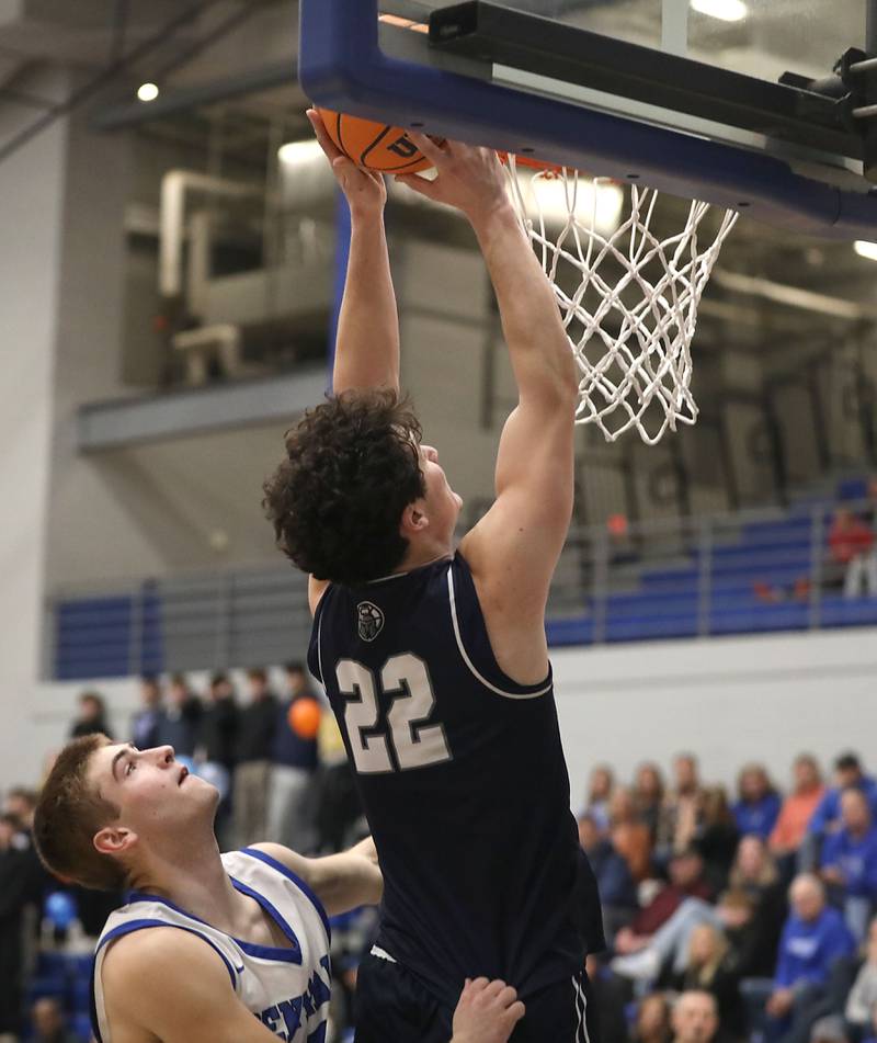 Cary-Grove's Adam Bauer dunks the basketball in front of Burlington Central's Bennek Braden during a Fox Valley Conference boys basketball game on Friday, February. 6, 2026, at Burlington Central High School.
