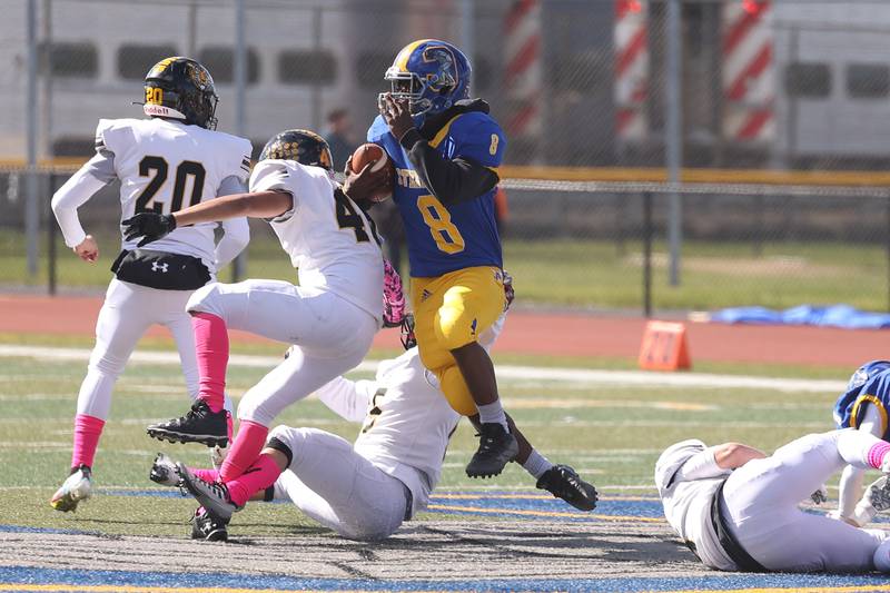 Joliet Central’s Jaylen Murphy powers past several Joliet West defenders during a return on Saturday.