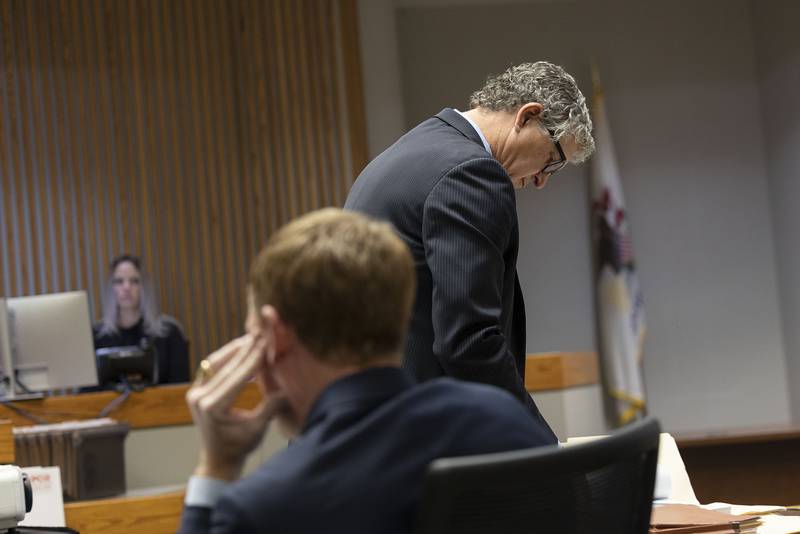 Defense attorney Michael Kujawa reads over his notes during his cross examination of retired Sterling Fire Chief Michael Dettman Wednesday, Nov. 12, 2025.