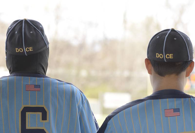 Marquette players wearing caps honoring Doyle Olson and Charlie Ellerbrock,