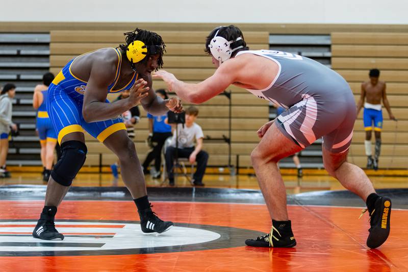 Joliet Central's Charles Walker takes on Colin Dominiak of Plainfield East in the 215-pound match at Plainfield East on Dec. 12, 2024.
