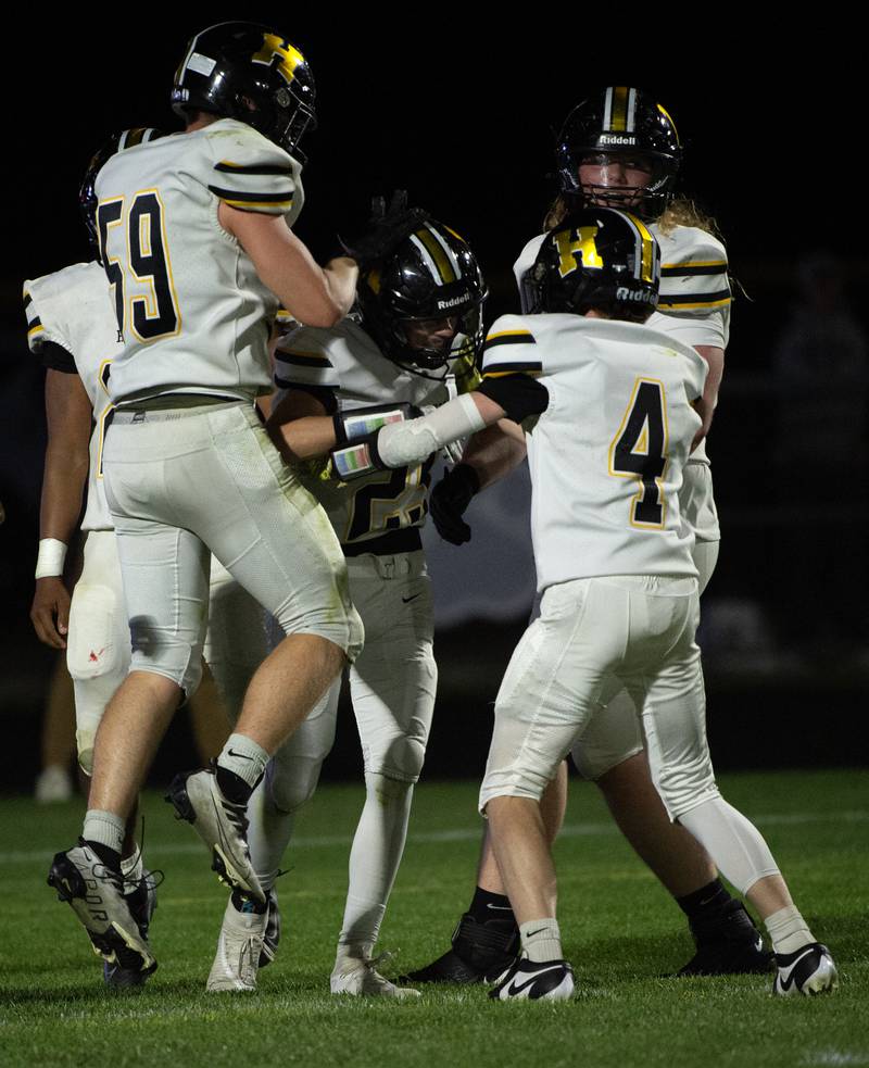 Teammates congratulate Herscher's Mason Roberts on his touchdown against Manteno on Friday, September 12, 2025.