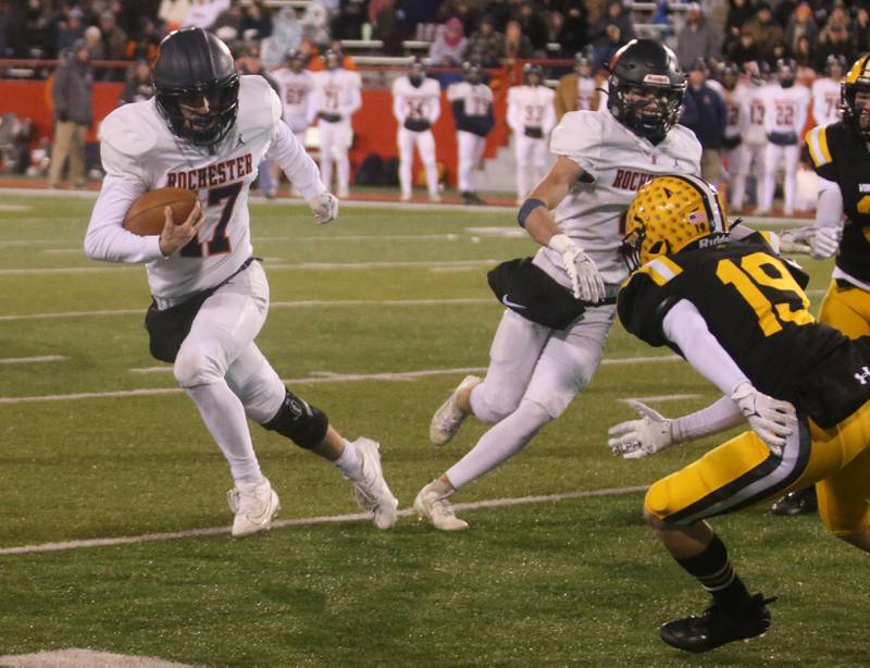 Rochester's Parker Gillespie runs the ball down the sidelines while St. Laurence's Jack Callaghan defends during the Class 4A State football championship on Friday, Nov, 24, 2023 at Hancock Stadium in Normal.