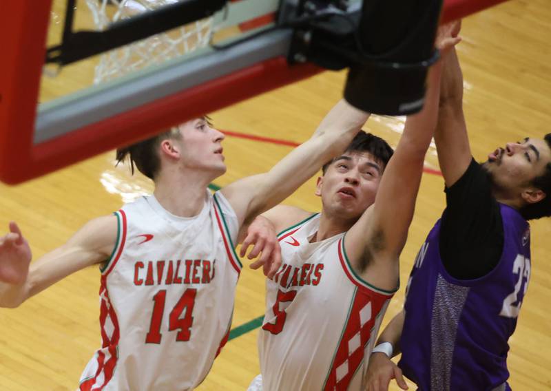L-P's Wyatt Kilday and Erick Sotelo jump for a rebound with Dixon's Zander Wilson during the Class 3A Regional semifinal game on Wednesday, Feb. 25, 2026 in Sellett Gymnasium at L-P High School.
