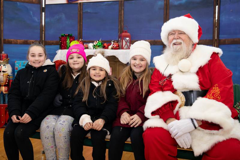 London, Wyndsor, Tenley, and Finley Diamond, of Mokena, visit with Santa at Christmas in the Square in Lockport on Saturday, Nov. 25, 2023.