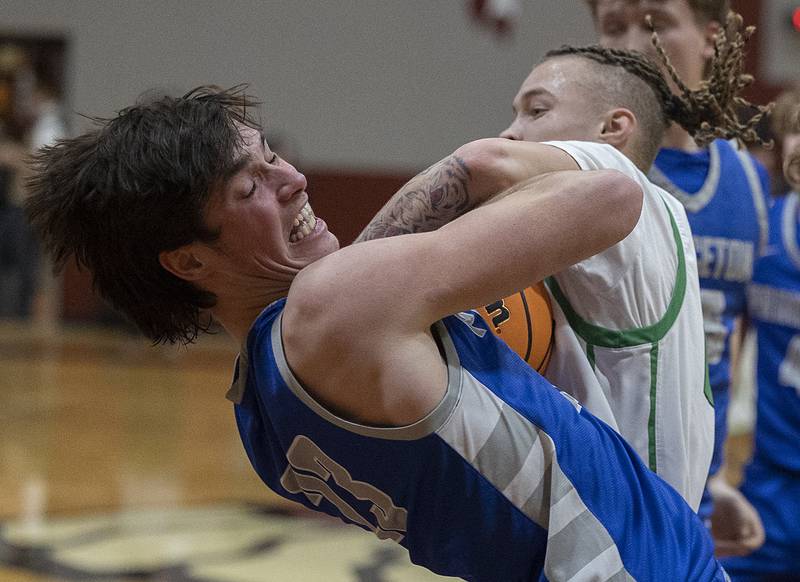 Rock Falls’ Nehemiah Menendez and Princeton’s Noah Laporte fight for a loose ball Friday, March 7, 2025, in the Class 2A boys basketball Sectional final in Marengo.