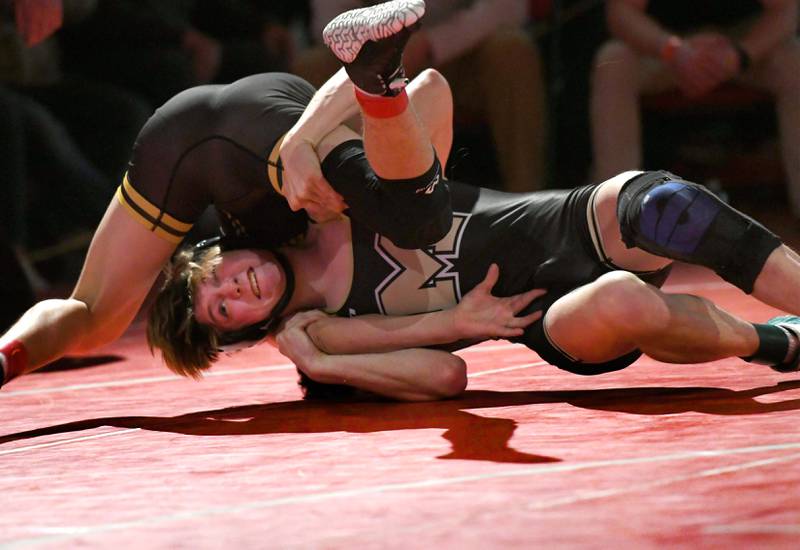 Polo's Wyatt Doty (bottom) tries to break free from Harvard's Marques Merida as they wrestle for third place at 132 pounds at the 1A Oregon Wrestling Sectional on Saturday. Doty won the match, but both wrestlers advance to the state finals.