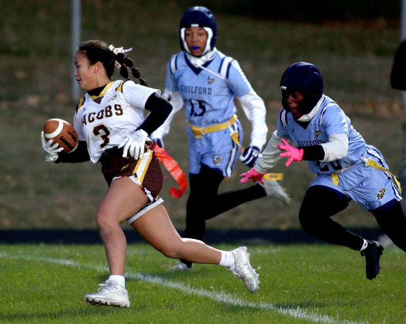 Jacobs’ Sophia Acot runs with the ball in for a touchdown against Rockford Guilford in varsity flag football sectional action at Dan Horne Field on the campus of Harvard High School in Harvard  on Tuesday, Oct. 15, 2024.
