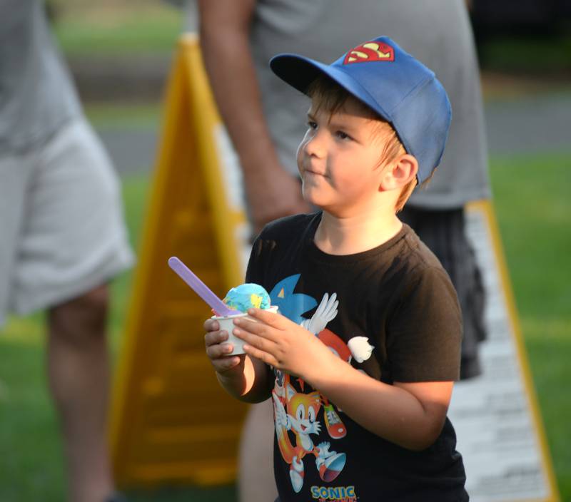 Oliver Sosa, 6, hangs on to his dish of ice cream from Just 4 Fun at the Oregon Park District's Concert in the Park on Tuesday, July 15, 2025 at Oregon Park West. E.D. Etnyre Co. sponsored the band Blue Steel for the outdoor concert.