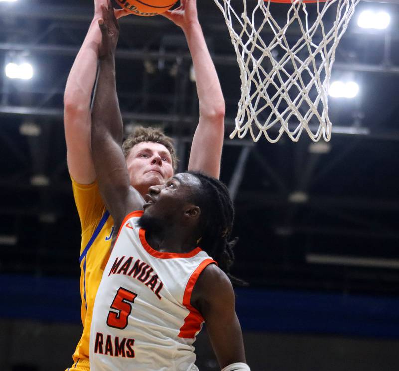 Johnsburg’s Josh Kaunas, back battles Peoria Manual’s Reginald Postlewaite for the ball in boys IHSA Class 2A Supersectional basketball on Monday, Mar. 9, 2026, at Sterling High School in Sterling.