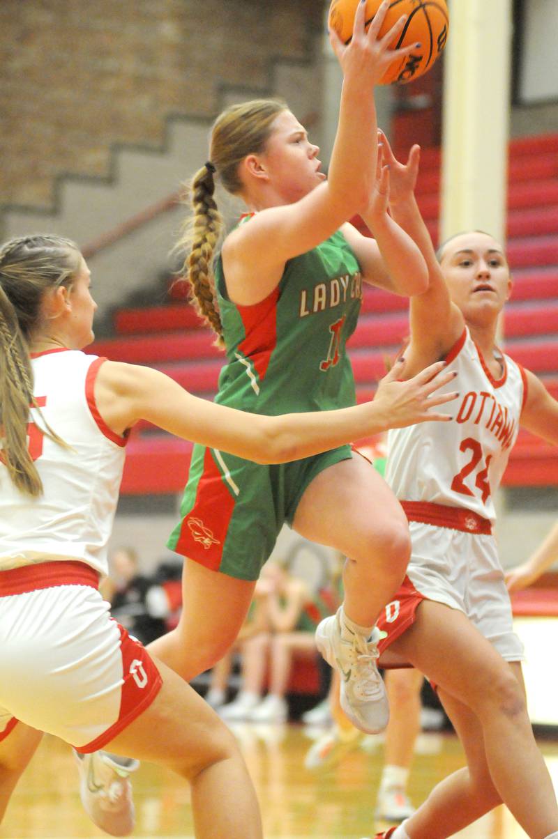 La Salle-Peru's Elizabeth Sines passes the ball while being defended by Ottawa's Ashlynn Ganiere on Friday, Dec. 13, 2024, at Kingman Gym.