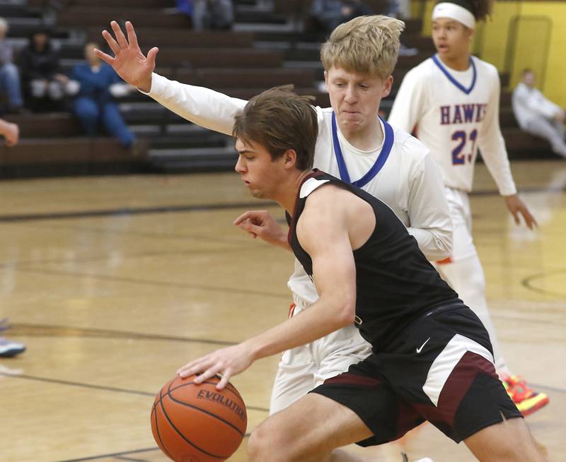 Prairie Ridge's Cade Collins tries to drive on Hoffman Estates’ Connor Kurzynski during a Hinkle Holiday Classic basketball game Wednesday, Dec. 28, 2022, at Jacobs High School in Algonquin.