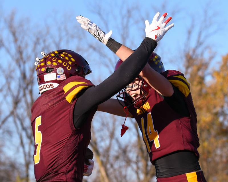 Montini Catholic's Nico Castaldo, left, celebrates with Johnny Neustadt (14) after Nico scored a touchdown while taking on Coal City during the 4A quarterfinals game on Saturday Nov. 15, 2025, held at Montini Catholic High School.