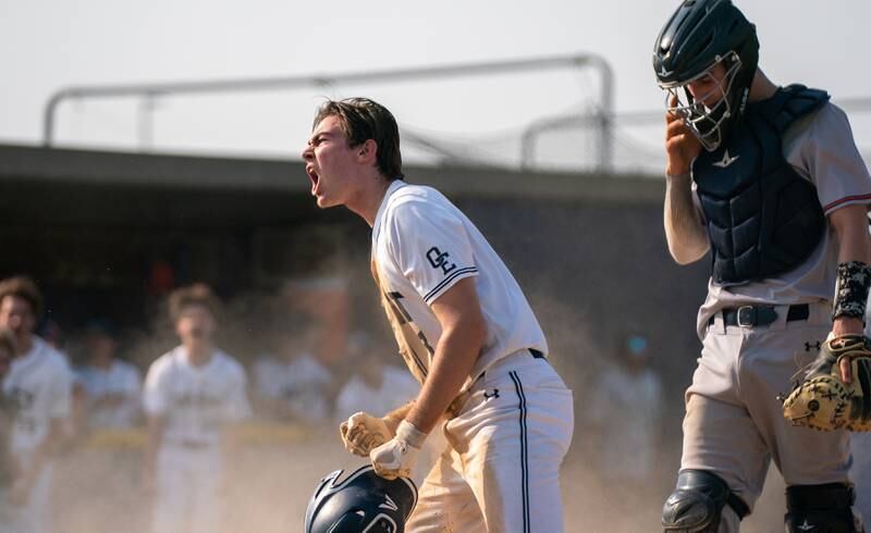 Oswego East's Noah Dowler (8) reacts after scoring against Oswego during a baseball game at Oswego East High School on Tuesday, May 10, 2022.