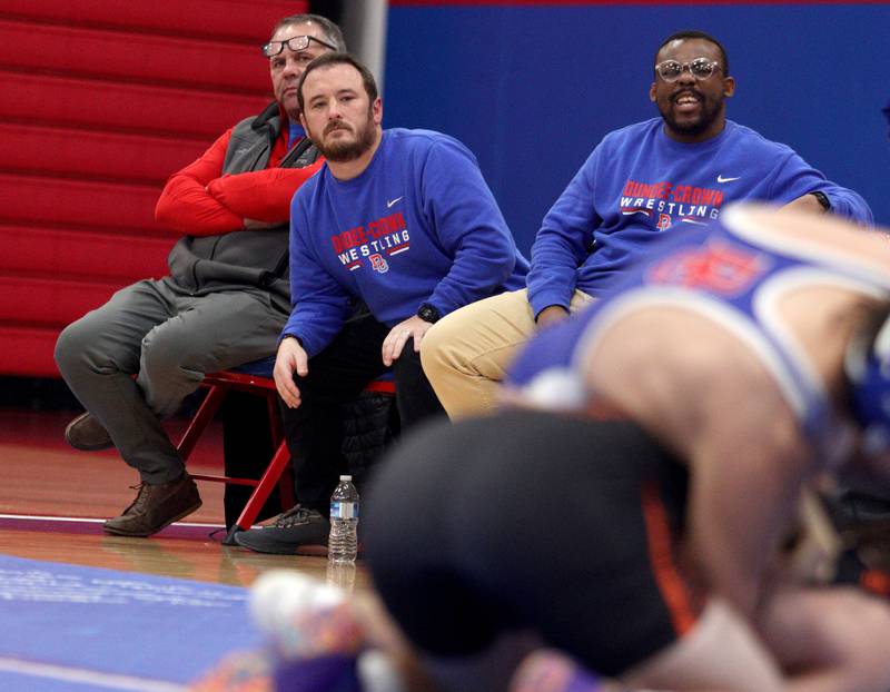 Dundee-Crown’s Head Coach Tim Hayes monitors the action against McHenry  in varsity wrestling at Carpentersville Thursday night.