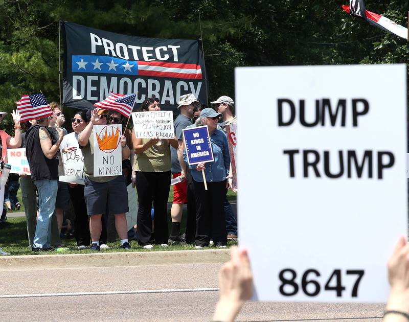 DeKalb Police Chief David Byrd talks to protesters Saturday, June 14, 2025, during a No Kings rally along Sycamore Road at Hopkins Park in DeKalb. The group was protesting the policies of President Donald Trump and his administration.