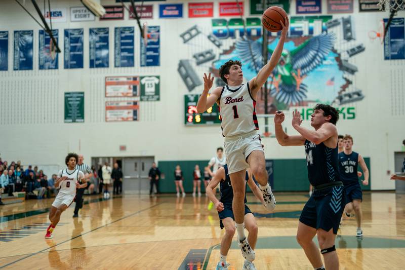 Benet’s Sam Driscoll (1) drives to the basket against Lake Park's Dennasio LaGioia (24) during a Bartlett 4A Sectional semifinal boys basketball game at Bartlett High School on Tuesday, Feb 28, 2023.