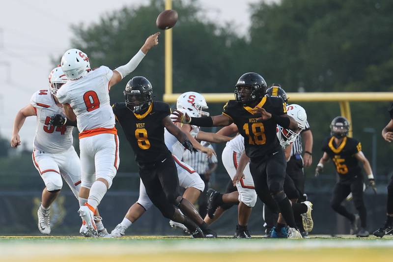 Joliet West’s Micah McNair (8) and KeShawn Wiley put pressure on Shepard’s Jimmy Las Cola on Friday, Aug. 25, 2023 in Joliet.