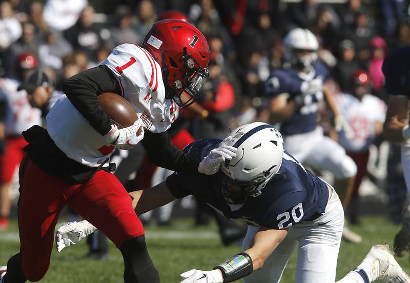 Huntley's Bryce Walker tries to avoid the tackle of Cary-Grove's Connor Anderson during a Fox Valley Conference football game on Saturday, Oct. 7, 2023, at Cary-Grove High School.